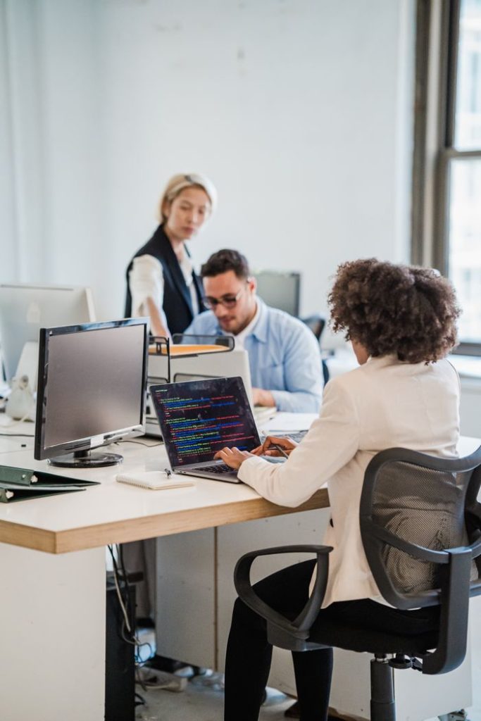 A diverse team engaging in professional work at a shared office space.
